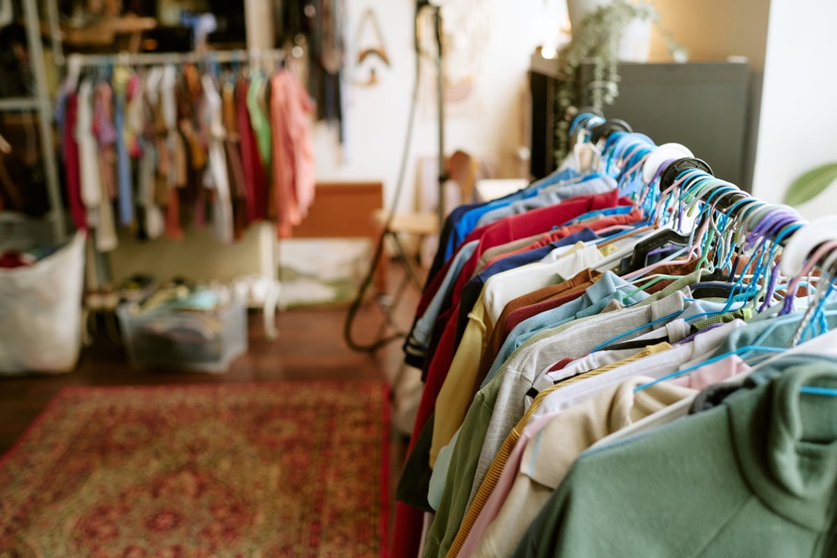 Assorted second hand clothing hanging on rack